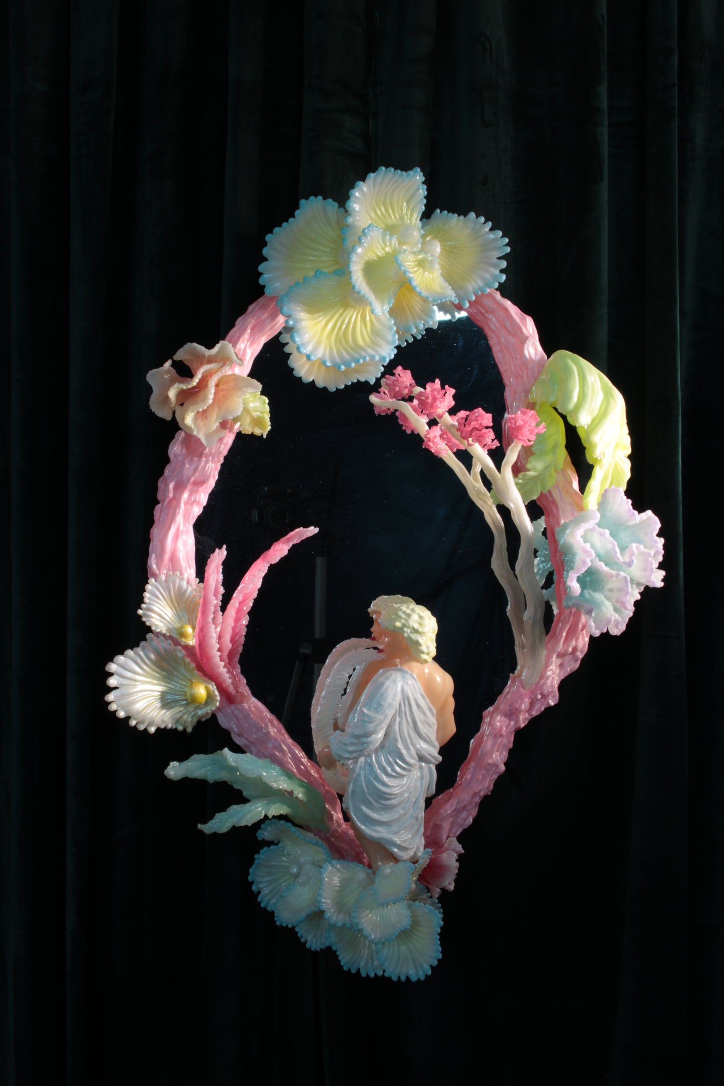 Licking leaves in the Garden — wall sculpture by Teemu Salonen, male figure before mirror with organic flowers, 2026